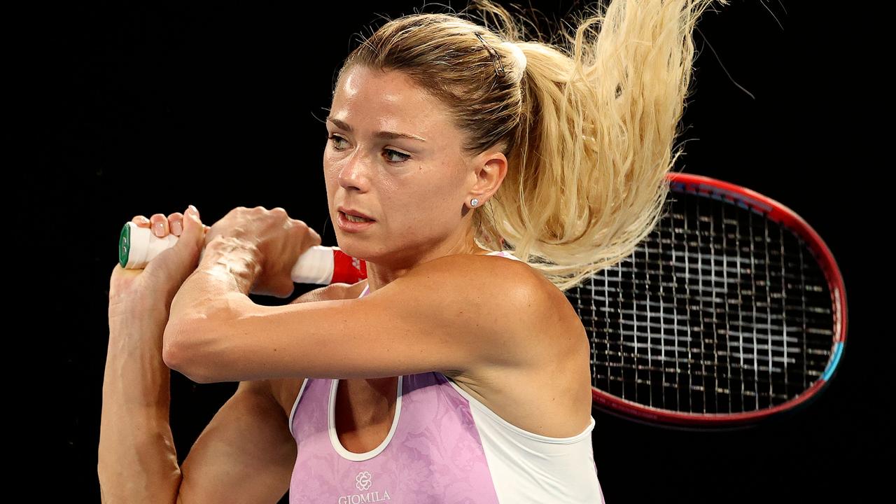 Italy's Camila Giorgi hits a return against Ashleigh Barty before bowing out in straight sets at the Australian Open.