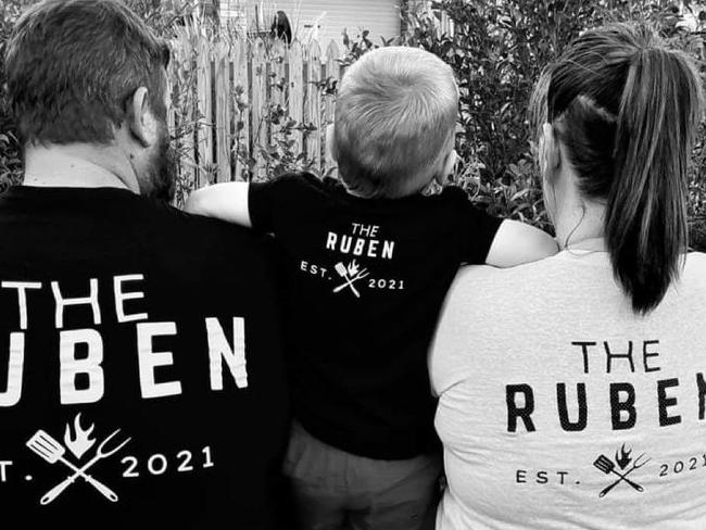 The Ruben Wood Smokers owners Carl Purdon and Lacey Marsh sporting their businesses merchandise with their son.