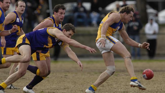 Kris Barlow gets a kick away for Noble Park against his old club Vermont.