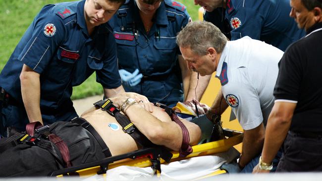 Langlands is treated by medical staff after falling from a car on a lap of honour.