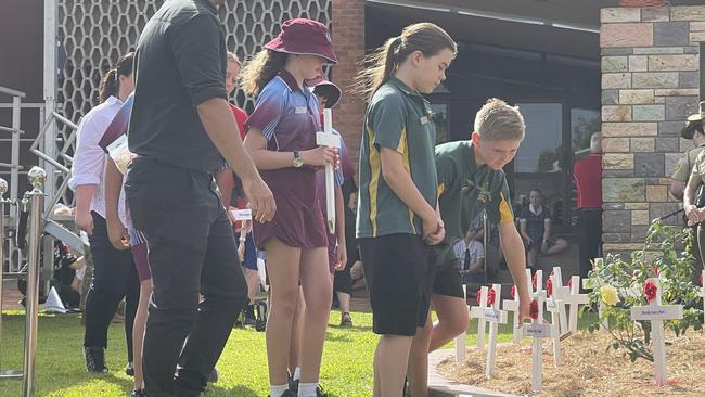 In a solemn and moving tribute, students also planted white crosses with red poppies in the ceremonial garden.