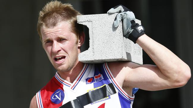 Filming of the footy reality show 'The Recruit'. Chris Moreland during the 6km concrete brick carrying challenge in 2014. Pic: Michael Klein