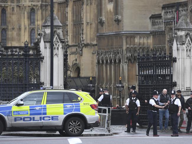 Police on the scene after sounds similar to gunfire were heard close to the Houses of Parliament in London. Picture: Victoria Jones/PA via AP