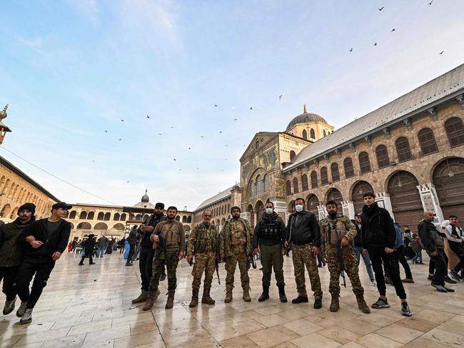 Syrian rebel fighters pose for a picture in the courtyard of the Omayyad Mosque in Damascus on Tuesday. Picture: AFP