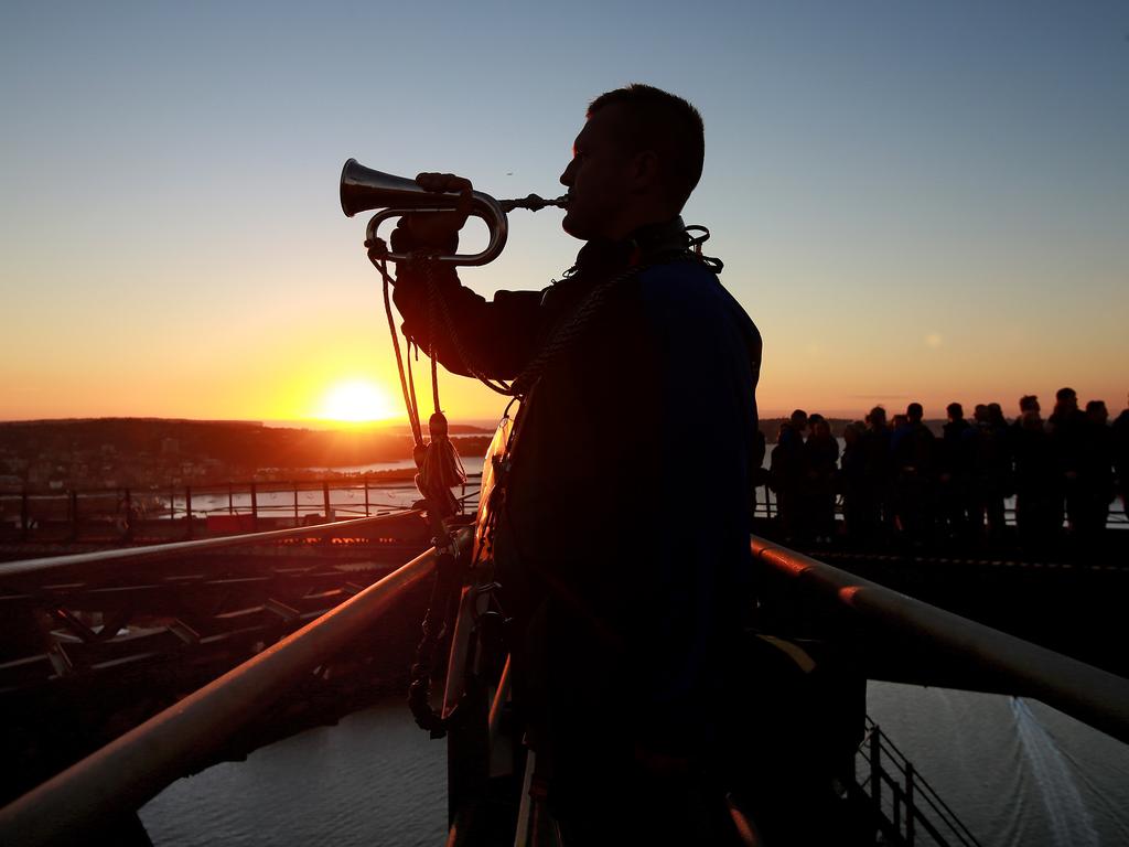 A dawn service was held on the summit of the Sydney Harbour Bridge to commemorate ANZAC Day. Bugler and Leading seaman Marcus Salone plays The Last Post on top of the bridge. Picture: Toby Zerna