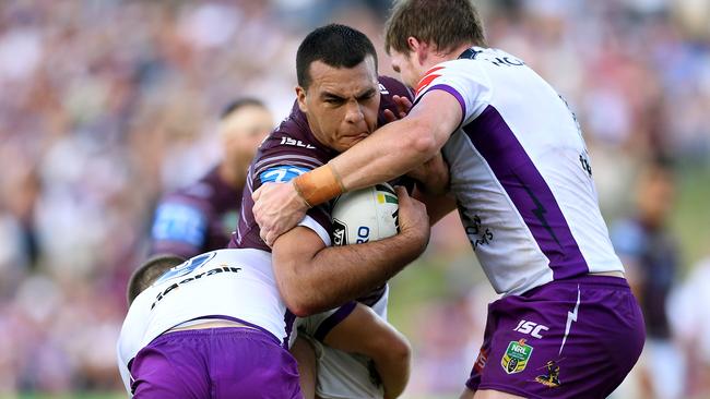 Lloyd Perrett of the Sea Eagles is tackled by Ryley Jacks, (left), and Tim Glasby of the Storm during the Round 7 NRL match between the Manly-Warringah Sea Eagles and the Melbourne Storm at Lottoland in Sydney, Saturday, April 15, 2017. (AAP Image/Dan Himbrechts) NO ARCHIVING, EDITORIAL USE ONLY