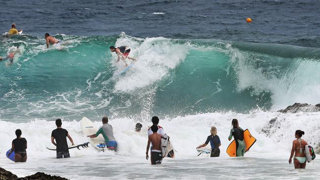 Surfers crowd Snapper Rocks as big swell pounds the coast. Picture: Luke Marsden.