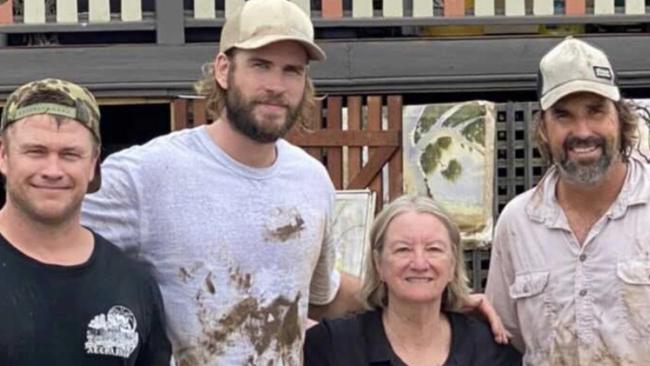 Luke Hemsworth (l to r), Liam Hemsworth and former tennis star Pat Rafter stopped for a snap with a local in flood-ravaged Lismore. Picture: Instagram