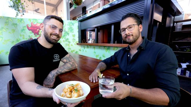 Chef Steve Maiden holds the Bang Bang Cauliflower next to owner Marc Grey. Picture: Steve Pohlner