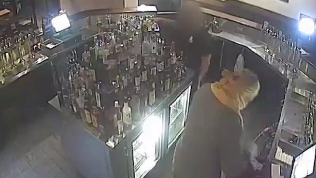 Police have released CCTV of the moment an inner-city hotel was robbed at knifepoint last month.