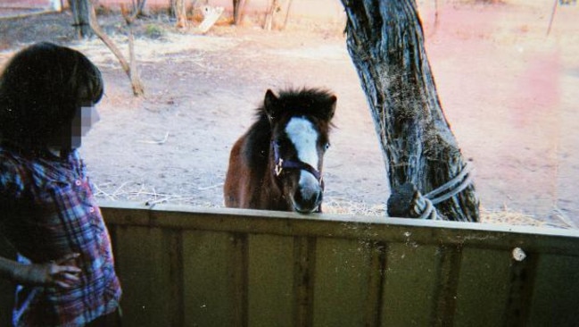 Colt family child with a horse on the farm in the remote hills behind Boorowa, NSW where the children lived in squalor and sexually abused each other. Picture: News Corp.