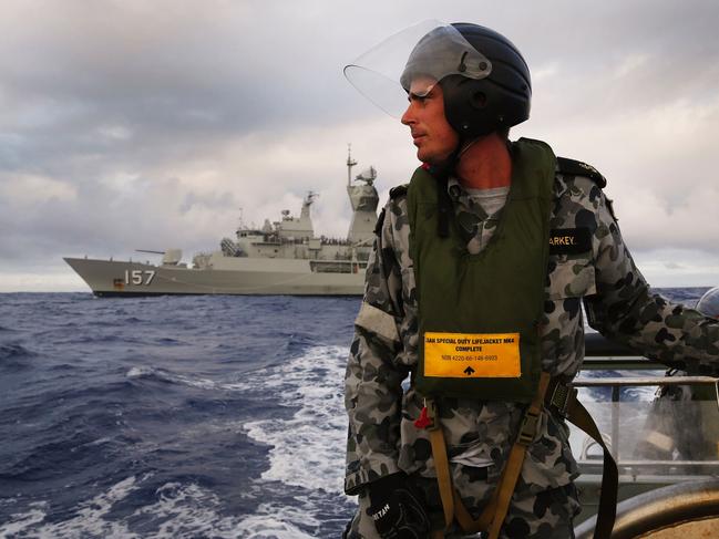 (FILES) This file handout photo taken on April 13, 2014 and obtained on April 17, 2014, shows Leading Seaman, Boatswain's Mate, William Sharkey searching for debris on a rigid hull inflatable boat as the HMAS Perth searches for missing Malaysia Airlines flight MH370 in the southern Indian Ocean. The official search for MH370 may have been called off but experts believe the missing airliner will one day be found, perhaps either by deep-sea miners or treasure hunters lured by a huge cash reward. After spending almost three years and 150 million USD on a deep sea hunt for the Malaysian passenger jet in the remote Indian Ocean off western Australia, top aviation investigators have been forced to admit they have come up with nothing.  / AFP PHOTO / AUSTRALIAN DEFENCE / ABIS NICOLAS GONZALEZ / ----EDITORS NOTE ----RESTRICTED TO EDITORIAL USE MANDATORY CREDIT " AFP PHOTO / AUSTRALIAN DEFENCE/ABIS NICOLAS GONZALEZ" NO MARKETING NO ADVERTISING CAMPAIGNS - DISTRIBUTED AS A SERVICE TO CLIENTS  -- TO GO WITH Australia-Malaysia-China-MH370-aviation,FOCUS by Glenda KWEK  /