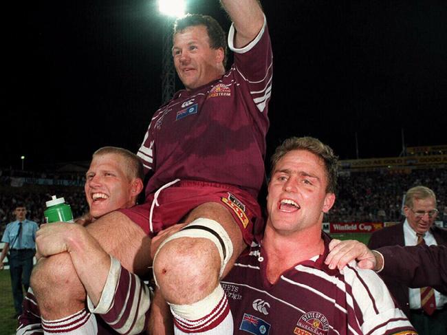 Gary Larson and Billy Moore chair captain Trevor Gillmeister off the field after victory in Game Three in 1995.