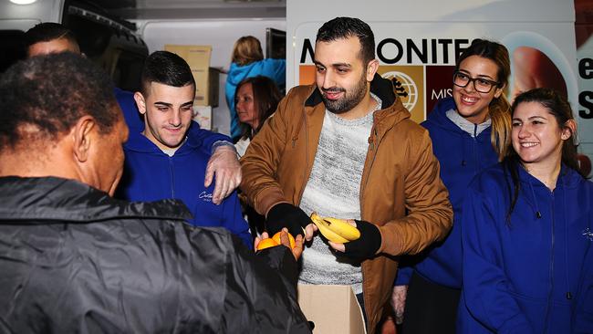 Charbel Azzi from Maronites on Mission is helped by Canterbury League Club volunteers to hand out food to the homeless in Woolloomooloo. Picture: Daniel Aarons