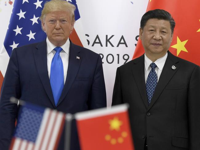 FILE - President Donald Trump, left, poses for a photo with Chinese President Xi Jinping during a meeting on the sidelines of the G-20 summit in Osaka, Japan, June 29, 2019. (AP Photo/Susan Walsh, File)