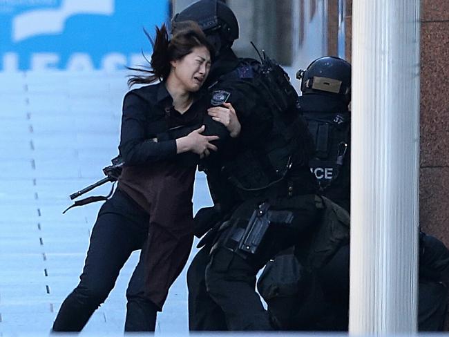 One of the horrific moments of the Lindt Cafe siege as a staff member fled the cafe. Picture: Adam Taylor