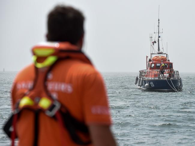 (FILES) In this file photo taken on June 28, 2019 a member of the French National Society of Sea Rescue (SNSM) looks at a rescue vessel as he takes part in a training session off Saint-Nazaire, western France. - Three children aged 7, 9 and 13 died when a small boat overtuned in the English Channel, near Agon-Coutainville, on August 12, 2019. (Photo by Sebastien SALOM-GOMIS / AFP)