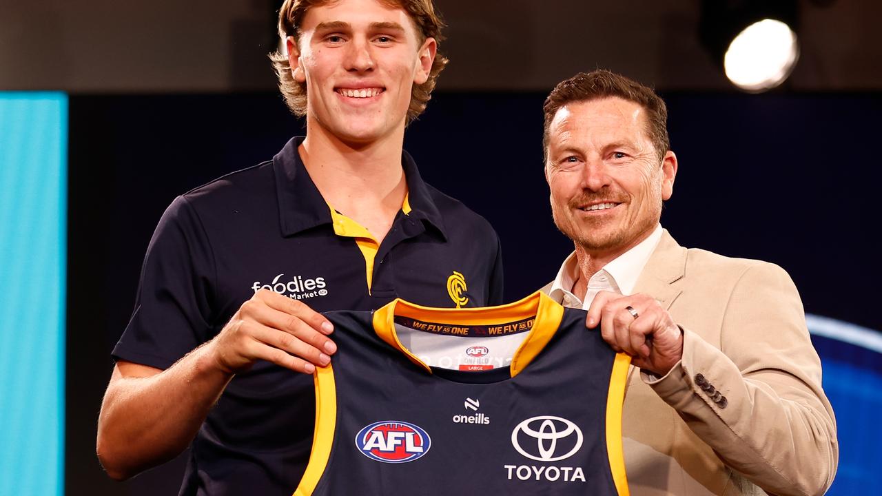MELBOURNE, AUSTRALIA - NOVEMBER 20: Daniel Curtin is seen with Mark Bickley after being selected at number eight by the Adelaide Crows during the 2023 AFL Draft at Marvel Stadium on November 20, 2023 in Melbourne, Australia. (Photo by Michael Willson/AFL Photos via Getty Images)