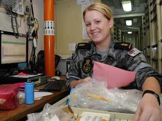 Able Seaman Lisa Thompson putting stock away on board HMAS Melbourne in the Gulf of Aden as part of Operation Slipper. . Picture: Contributed