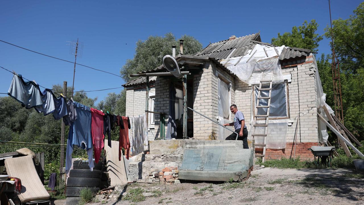 A local resident works outside his damaged house in Kharkiv as Russia claims it is advancing in the region again. Picture: AFP