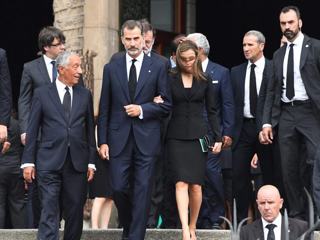 Spain's King Felipe VI (centre), Queen Letizia (right) and Portugal's President Marcelo Rebelo de Sousa (left) leave after a Mass to commemorate victims of two devastating terror attacks in Barcelona. Picture: AFP/Pascal Guyot