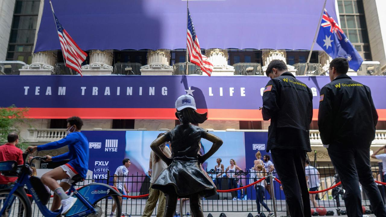 Traders stand in front of the New York Stock Exchange at Wall Street as the international fitness community F45 goes public on July 15. Picture: Angela Weiss/AFP