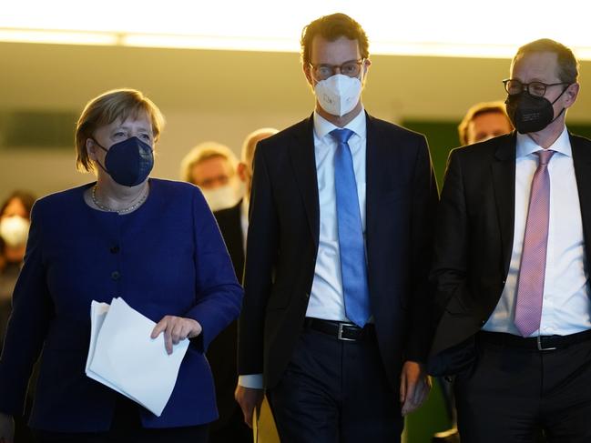 (L-R) Acting German Chancellor Angela Merkel, North Rhine-Westphalia State Premier Hendrik Wuest and Berlin acting Governing Mayor Michael Mueller. Germany is in its fourth wave of the pandemic. Picture: Getty