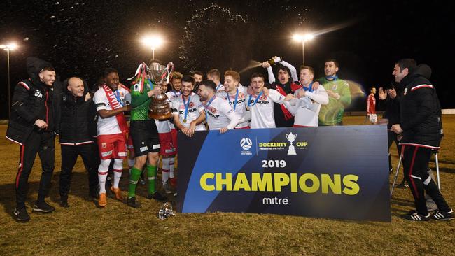 Hume City players and coaches celebrate their Dockerty Cup victory over Melbourne Knights. Picture: Mark Avellino, Football Victoria