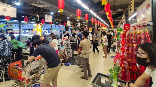 People queue to pay for groceries in a supermarket in Yangon after the coup. Picture: AFP.