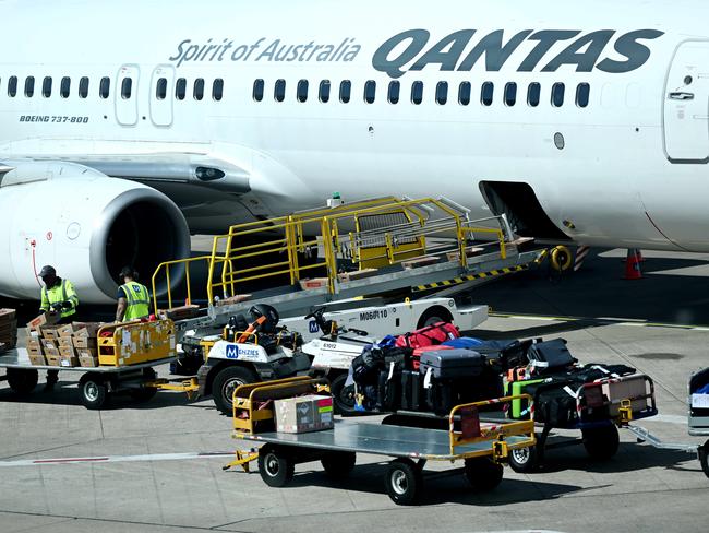 BRISBANE, AUSTRALIA - NewsWire Photos - AUGUST 11, 2022. Qantas baggage handlers at work at Brisbane airport. Industrial action will start at Qantas and budget offshoot Jetstar by the end of August amid an escalating fight over pay with its licensed engineers.Picture: NCA NewsWire / Dan Peled