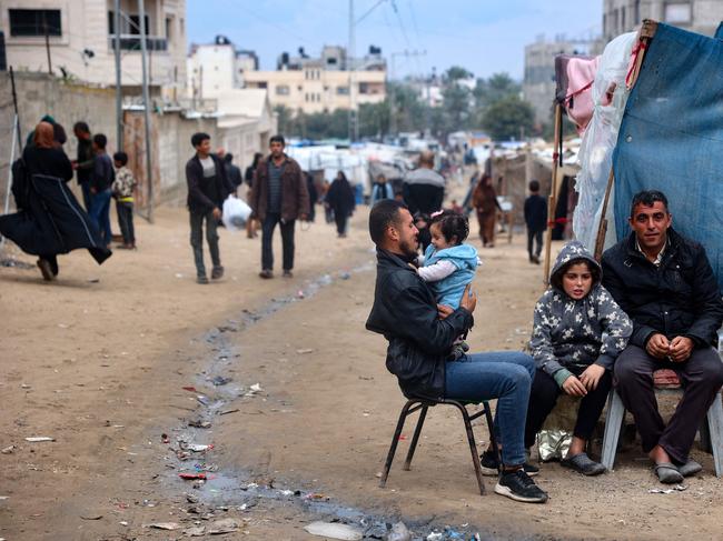 A man plays with a baby in Gaza. Picture: AFP