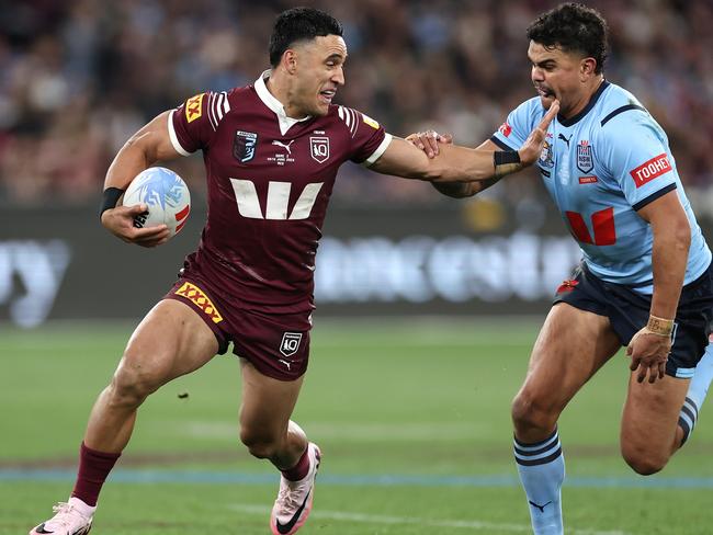 MELBOURNE, AUSTRALIA - JUNE 26: Valentine Holmes of the Maroons fends Latrell Mitchell of the Blues during game two of the men's State of Origin series between New South Wales Blues and Queensland Maroons at the Melbourne Cricket Ground on June 26, 2024 in Melbourne, Australia. (Photo by Cameron Spencer/Getty Images)