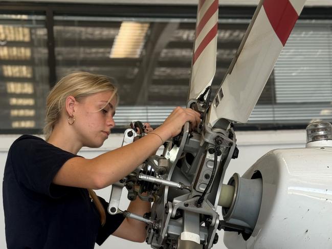 Bethany Heintze works on a helicopter at the LifeFlight Sunshine Coast base. Supplied: LifeFlight