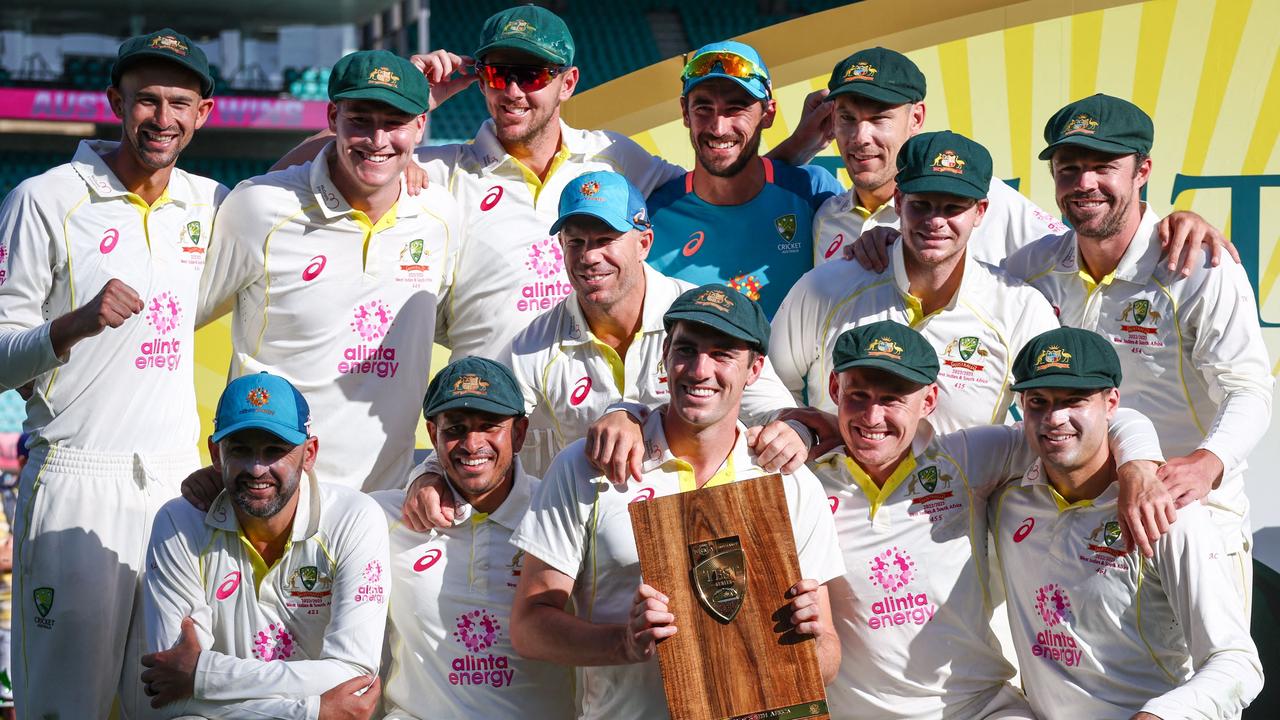 Australia’s captain Pat Cummins holds the ‘cheeseboard’ trophy with teammates. Picture: AFP