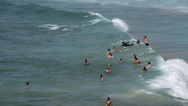 Surfers cool down at Coogee Beach. Picture: NewsWire / Monique Harmer