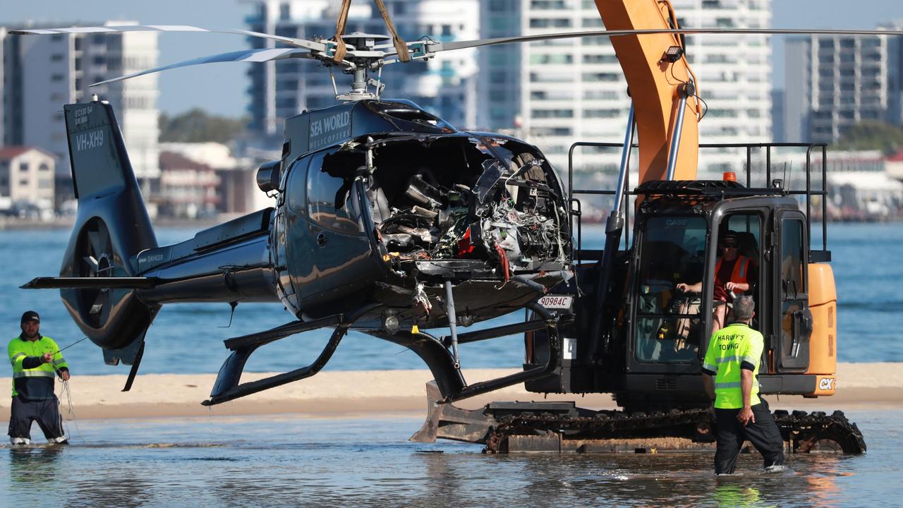 Queensland Police and ATSB Officers recover the wreckage after four people were killed and many more injured after two helicopters collided near Sea World on the Gold Coast, 03 January 2023. Picture Scott Powick