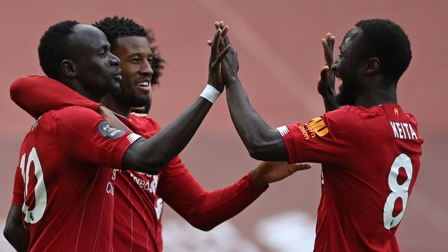 Sadio Mane (left) celebrates scoring his team's first goal. (Photo by Shaun Botterill/AFP)