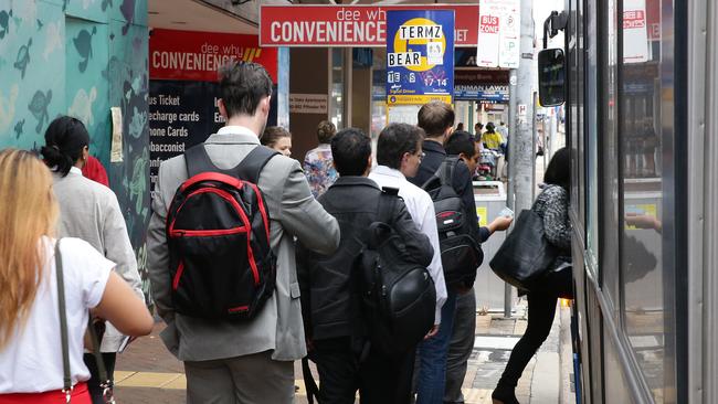 People queue at Dee Why to get on the bus to the Sydney CBD.