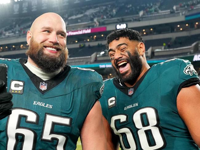 PHILADELPHIA, PENNSYLVANIA - JANUARY 12: Lane Johnson #65 and Jordan Mailata #68 of the Philadelphia Eagles celebrate beating the Green Bay Packers 22-10 during the NFC Wild Card Playoff at Lincoln Financial Field on January 12, 2025 in Philadelphia, Pennsylvania.   Mitchell Leff/Getty Images/AFP (Photo by Mitchell Leff / GETTY IMAGES NORTH AMERICA / Getty Images via AFP)