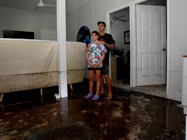 Tuesday February 4. Heavy rain causes flooding in North Queensland. Bluewater residents Anthony Waugh, with daughter Nyah, 9, at the ground floor of their Forrestry Road home inundated by a fast rising Bluewater Creek. Picture: Evan Morgan