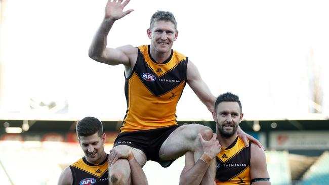 Ben McEvoy is chaired off the ground by Hawthorn teammates Luke Breust and Jack Gunston late last season. Picture: Dylan Burns/AFL Photos via Getty Images