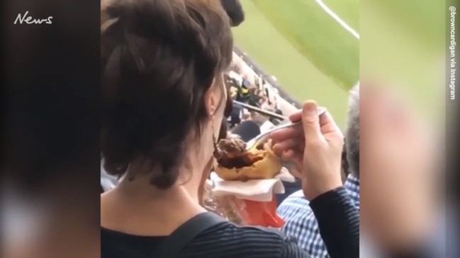 A footy fan desecrates Aussie meat pie