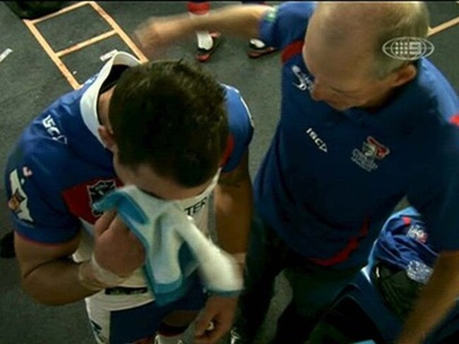 An emotional Darius Boyd (L) is consoled by coach Wayne Bennett in the dressing rooms during halftime in the Sydney Roosters v Newcastle Knights NRL game at Allianz Stadium in Sydney, 06/05/2012. Pic Channel 9.