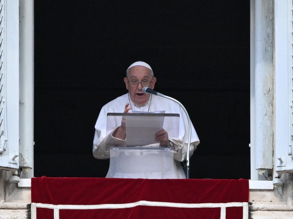 Pope Francis addresses the crowd from the window of the apostolic palace overlooking St. Peter's square during the weekly Angelus prayer in The Vatican. Picture: AFP