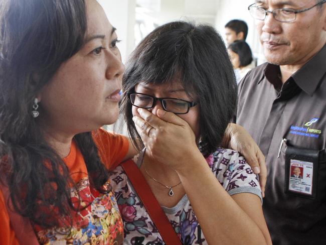 A relative of an Air Asia flight QZ8501 passenger weeps as she waits for the latest news on the missing jetliner at Juanda International Airport in Surabaya, Indonesia.