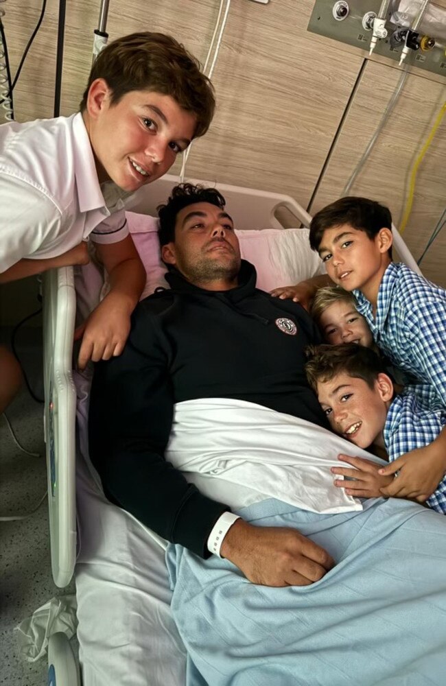 Dan Fong with his sons in hospital. Picture – contributed.