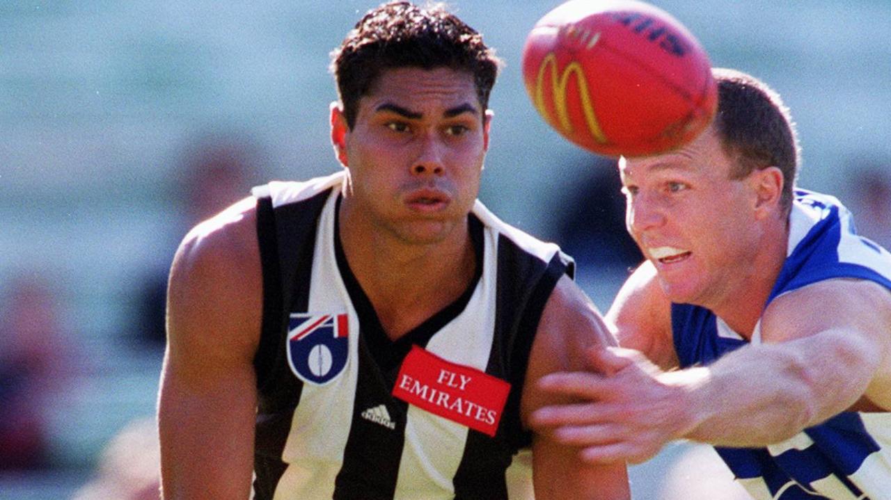 Collingwood v Kangaroos. Collingwood's Mal Michael handballs clear of Kangaroo John Blakey. f/l. a/ct. 2 May 1999./football