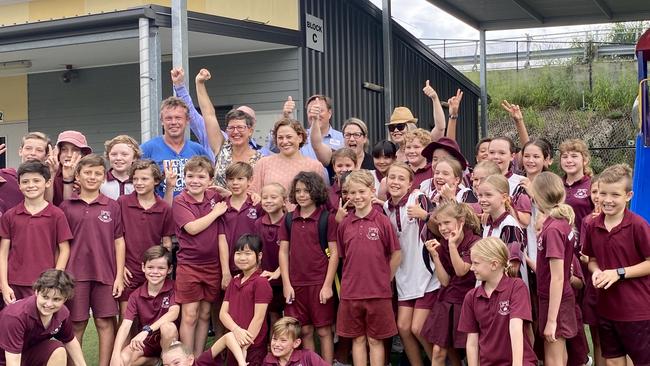 Buranda State School students and P&amp;C president Craig Unthank (blue shirt, left rear) celebrate the win this morning.