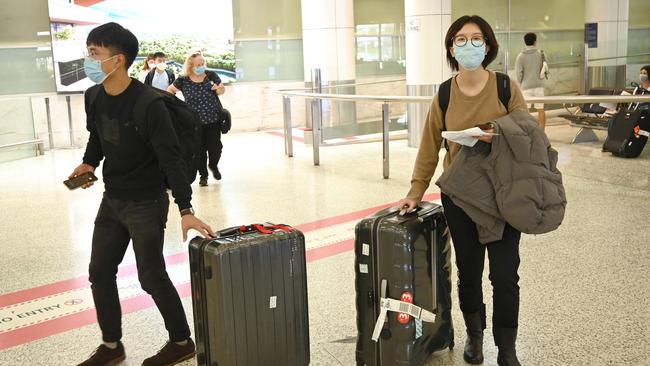 Passengers arrive at Sydney International Airport on Monday. Picture: AFP