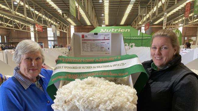 Alison van Eyk from Shalimar Park Merino stud at Walcha, NSW, and Australian Fleece Competition co-ordinator Candice Cordy from Nutrien Ag Solutions with the grand champion fleece at the Australian Sheep and Wool Show at Bendigo.